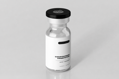 Vaccine bottle with a white label on a gray background
