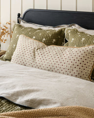 Thea Clay Block Print Large Lumbar Pillow shown on bed