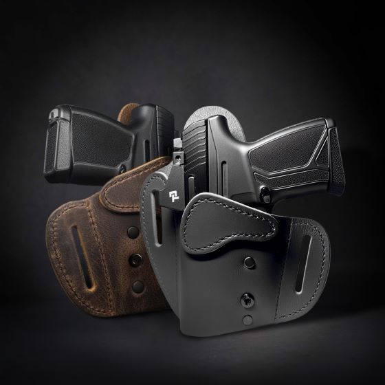 Three leather OWB (Outside-the-Waistband) holsters, two in black and one in brown, displayed with firearms inserted, against a dark background.