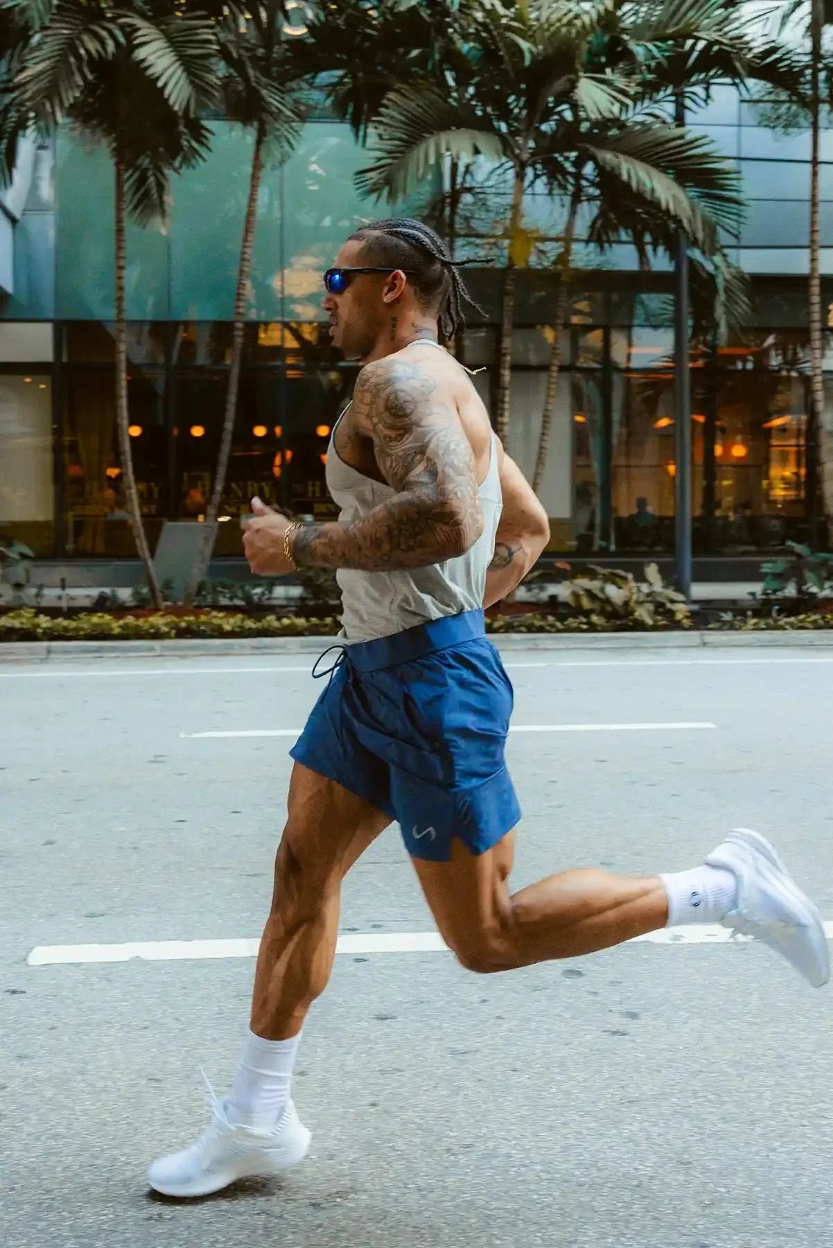 Side View of the Blue the TLF Element Light 7 Inch Shorts featuring side zipper pockets, side split hems and reflective details for nighttime visibility.