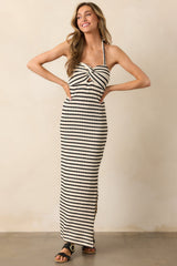 A striped maxi dress featuring a self-tie halter neckline, twist detailing at the bust, a chest cutout, and a flowing silhouette.