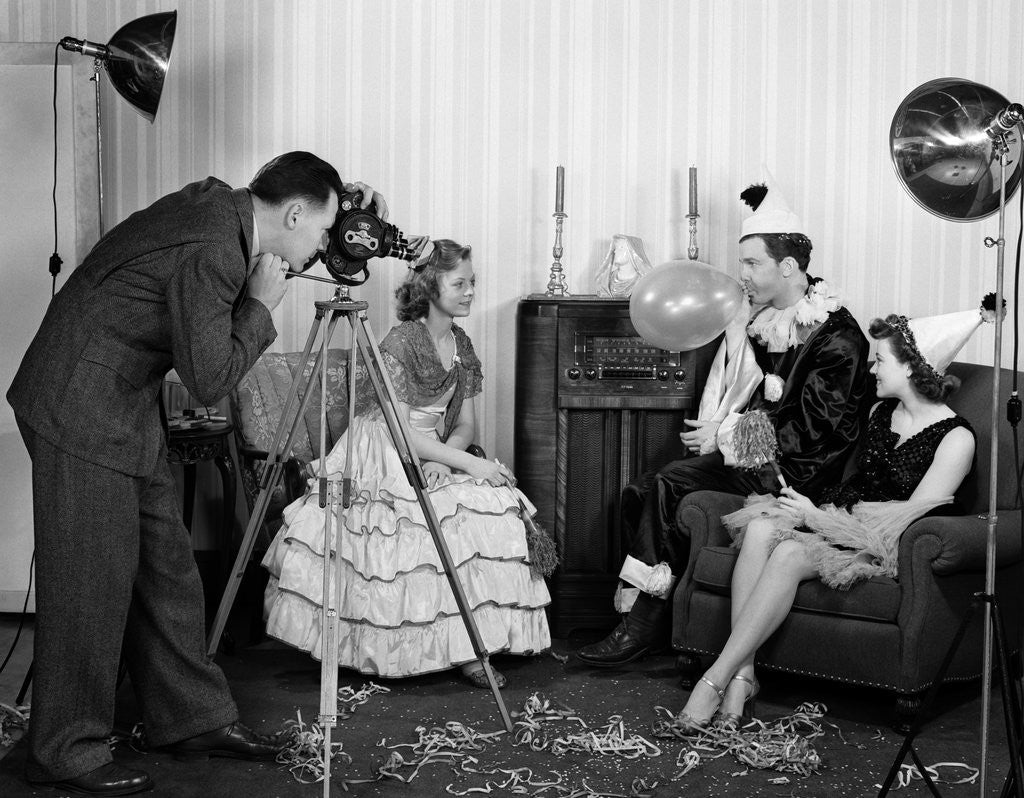 1940s photographer taking picture of young people at New Years party