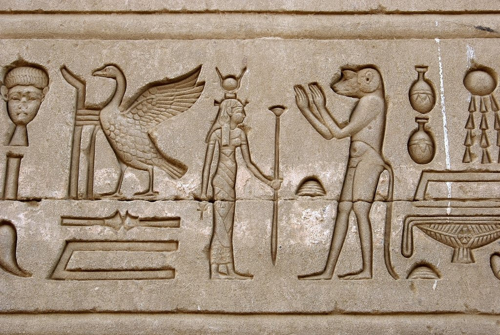 Ancient Egyptian hieroglyphs carved on the wall of Hathor Temple