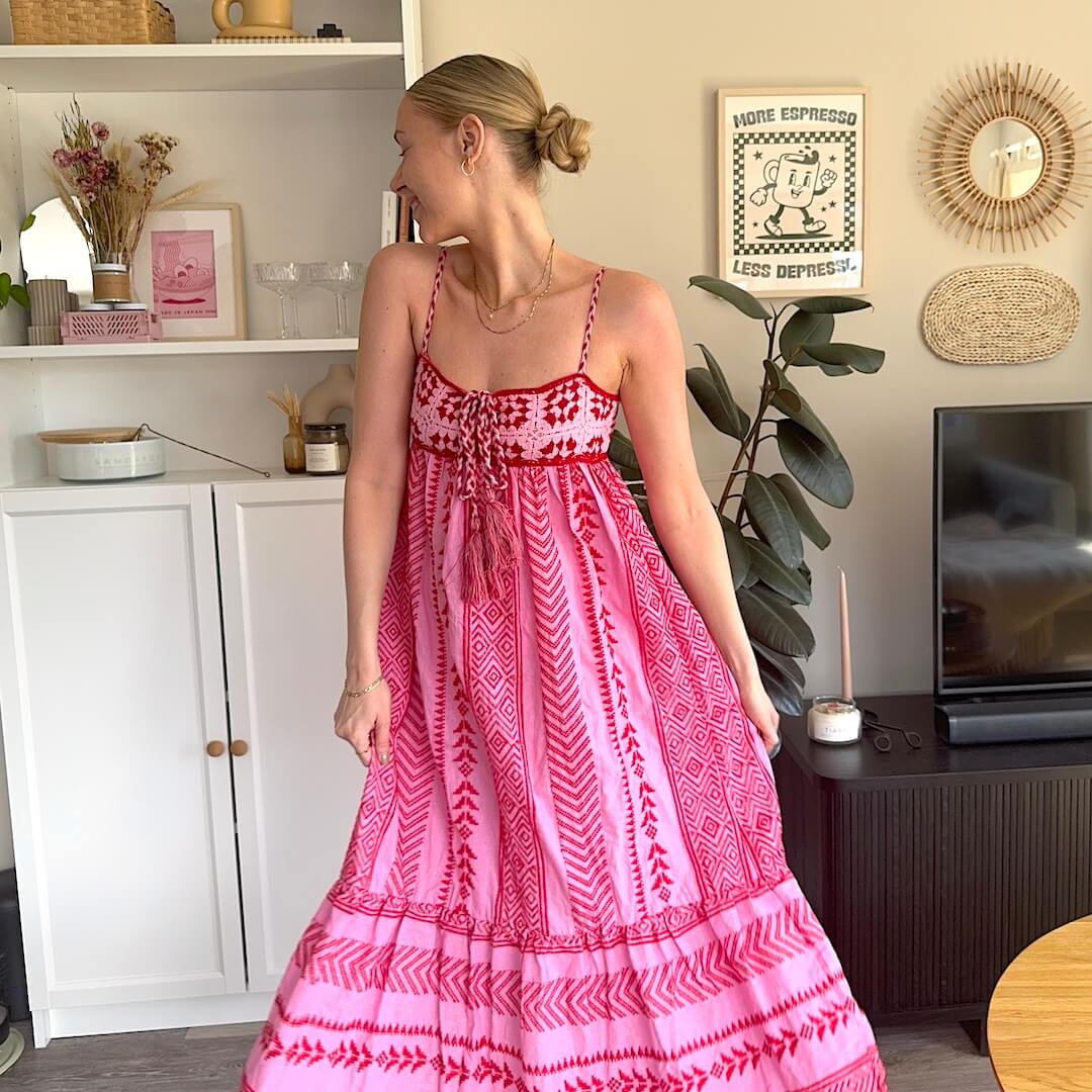 Woman in pink patterned maxi dress.