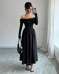 An elegant black off-the-shoulder pleated long-sleeve maxi dress, showcasing a sophisticated style