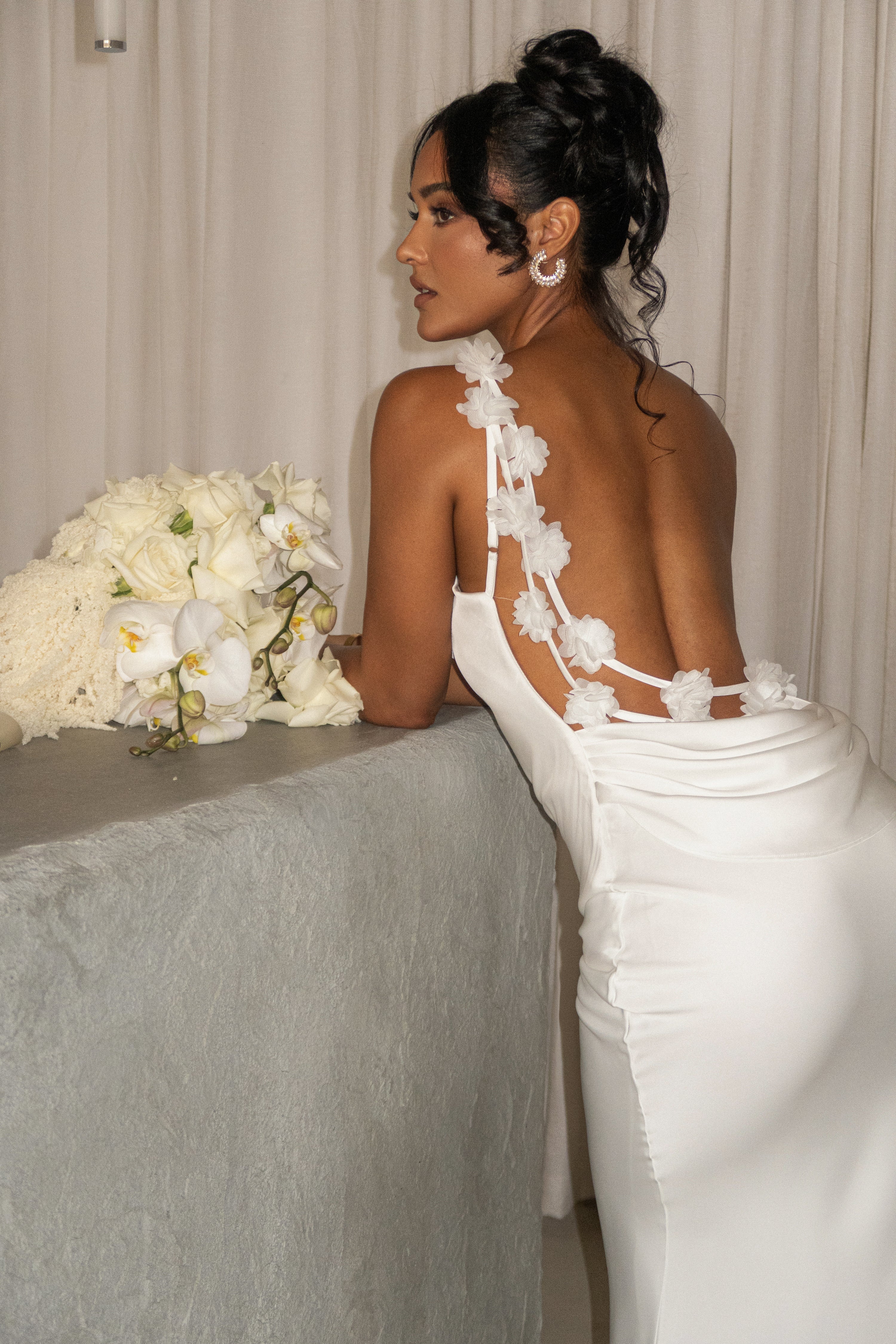 Ivory satin bridal gown from JLUXLABEL’s Down The Aisle collection, featuring elegant design and flowing fabric.