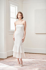 Bride wearing flattering white beaded strapless tea length casual mermaid twirling first dance wedding dress and honeymoon dress
