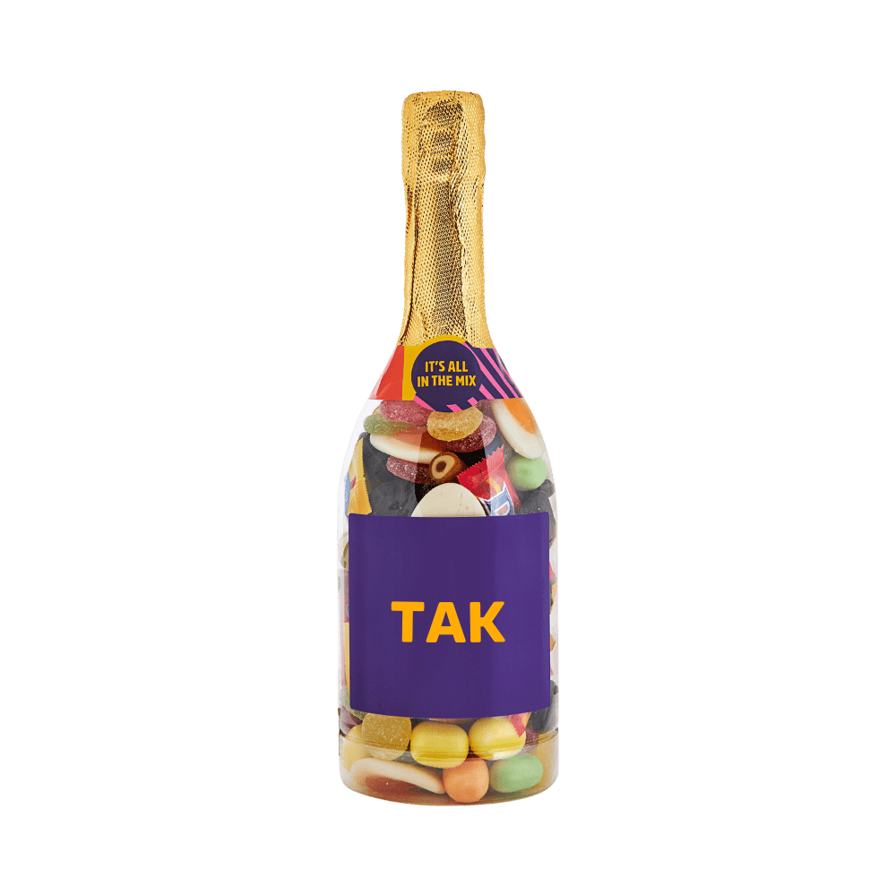 Champagneflaske fyldt med farverigt slik med teksten TAK på etiketten. Gaveidé fra SlikEkspressen.