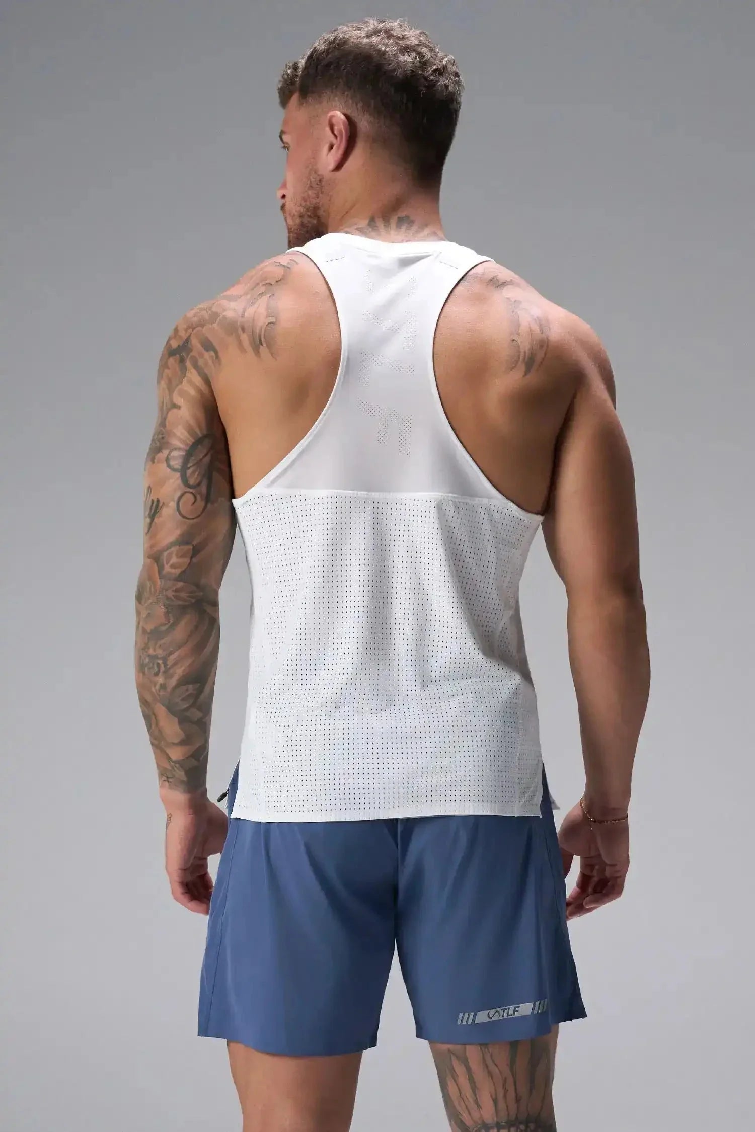 Back View of the Blue the TLF Element Light 7 Inch Shorts featuring side zipper pockets, side split hems and reflective details for nighttime visibility. 