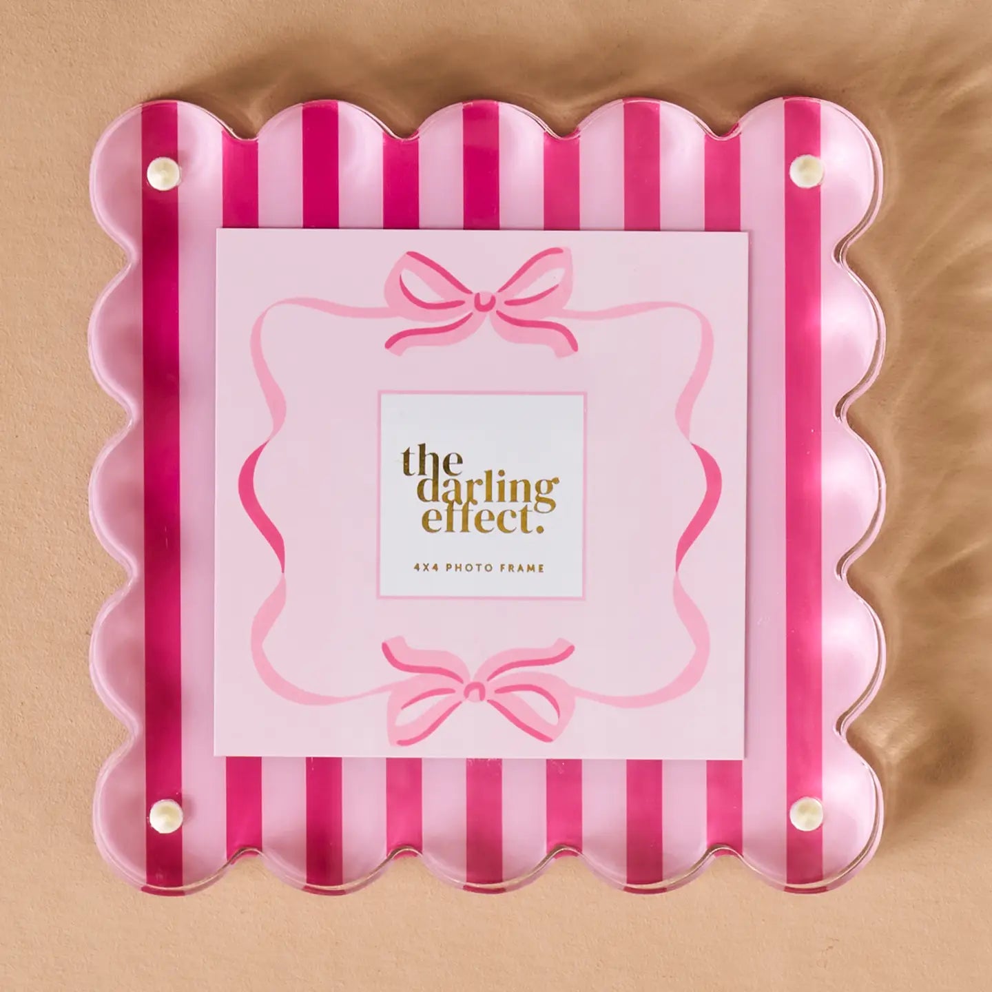 Pink and red striped photo frame  on a beige background