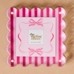 Pink and red striped photo frame  on a beige background